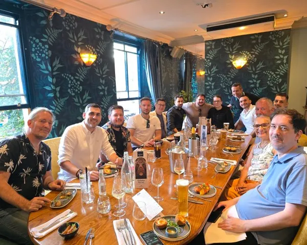 Retirement celebration with gifts, a framed team photograph and a congratulatory card