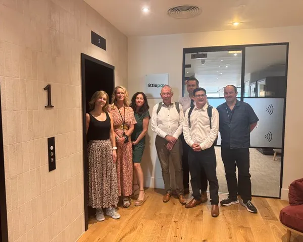 Imaginet and Littlepay teams at the entrance to the Littlepay office
