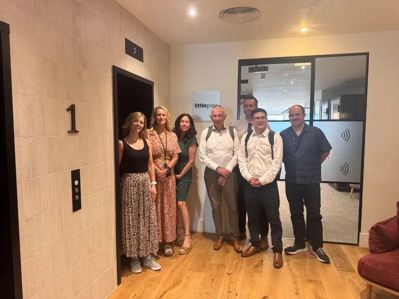 Imaginet and Littlepay teams at the entrance to the Littlepay office